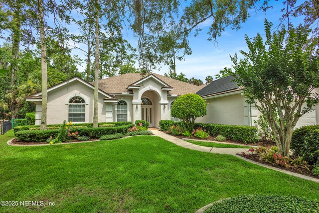 445 W Mill Chase Ct, Ponte Vedra Beach, FL 32082 - view of front facade with stucco siding, a front yard, roof with shingles, and french doors