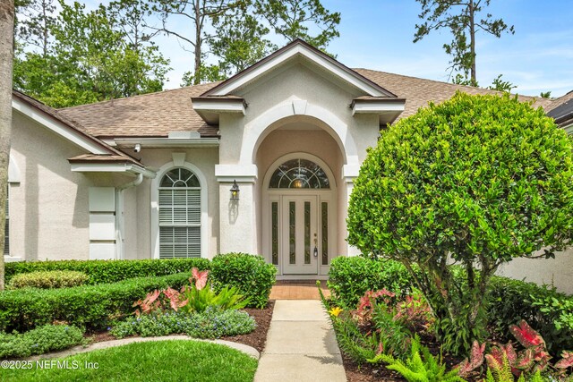 445 W Mill Chase Ct, Ponte Vedra Beach, FL 32082 - doorway to property featuring a shingled roof, stucco siding, and french doors