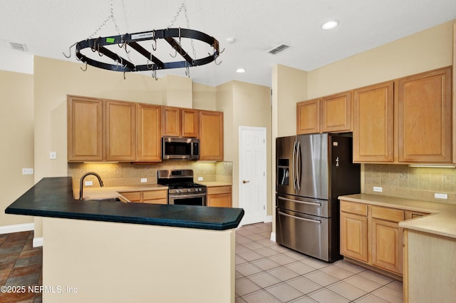 445 W Mill Chase Ct, Ponte Vedra Beach, FL 32082 - kitchen with stainless steel appliances, a sink, a peninsula, baseboards, and tasteful backsplash