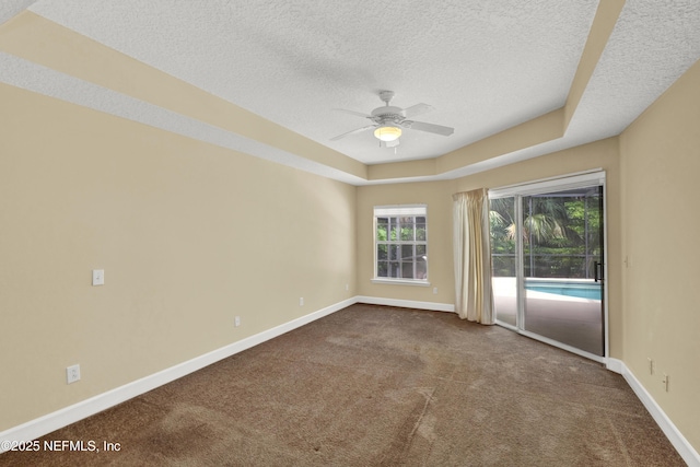 445 W Mill Chase Ct, Ponte Vedra Beach, FL 32082 - unfurnished room featuring a textured ceiling, dark colored carpet, baseboards, ceiling fan, and a raised ceiling