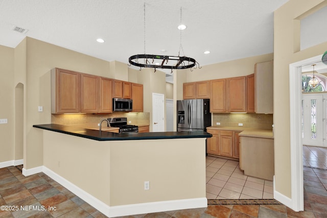 445 W Mill Chase Ct, Ponte Vedra Beach, FL 32082 - kitchen with appliances with stainless steel finishes, a chandelier, decorative backsplash, a peninsula, and dark countertops