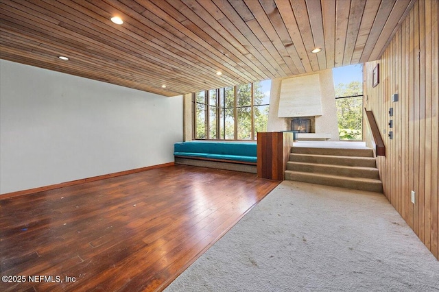7868 Woodsdale Ln, Jacksonville, FL 32256 - unfurnished living room featuring hardwood / wood-style floors, stairway, recessed lighting, wooden ceiling, and wood walls