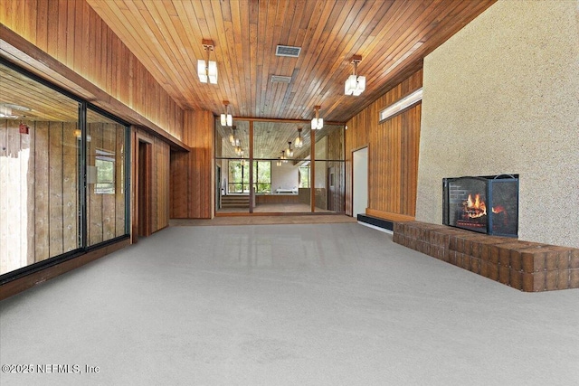 7868 Woodsdale Ln, Jacksonville, FL 32256 - unfurnished living room featuring a brick fireplace, wooden walls, and wooden ceiling