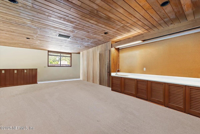 7868 Woodsdale Ln, Jacksonville, FL 32256 - basement with carpet flooring, wood ceiling, and a sink