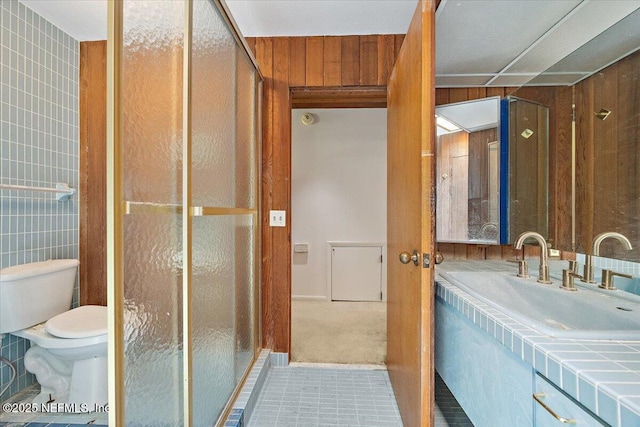 7868 Woodsdale Ln, Jacksonville, FL 32256 - bathroom with vanity, a stall shower, toilet, and tile patterned floors