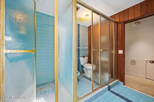 7868 Woodsdale Ln, Jacksonville, FL 32256 - bathroom featuring toilet, tile patterned flooring, and a stall shower