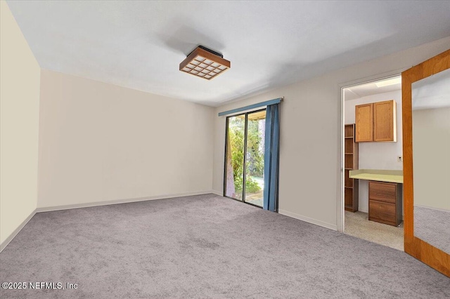 7868 Woodsdale Ln, Jacksonville, FL 32256 - unfurnished bedroom featuring light carpet and baseboards
