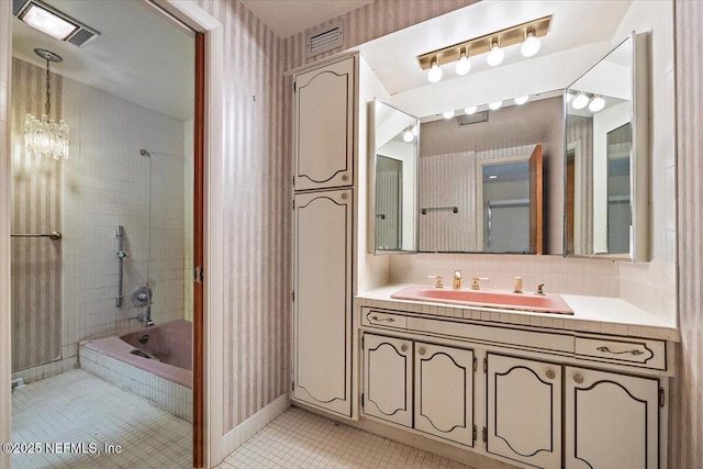 7868 Woodsdale Ln, Jacksonville, FL 32256 - full bath featuring tile patterned flooring, vanity, shower / bath combination, wallpapered walls, and baseboards