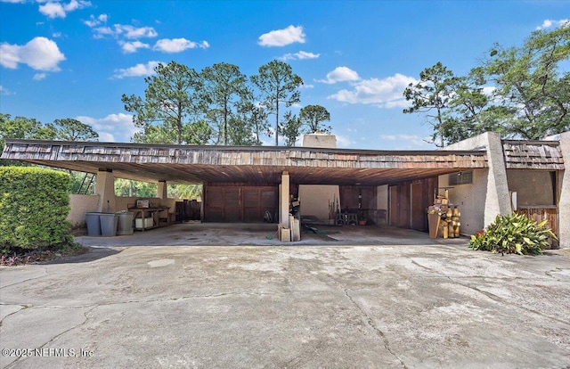 7868 Woodsdale Ln, Jacksonville, FL 32256 - view of parking / parking lot featuring driveway and a carport