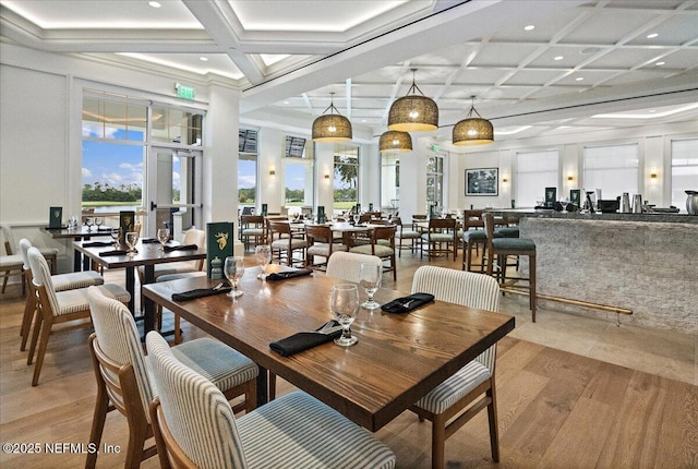 7868 Woodsdale Ln, Jacksonville, FL 32256 - dining space with coffered ceiling, light wood-style flooring, recessed lighting, beam ceiling, and a high ceiling