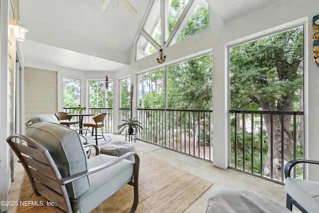 sunroom with ceiling fan and vaulted ceiling