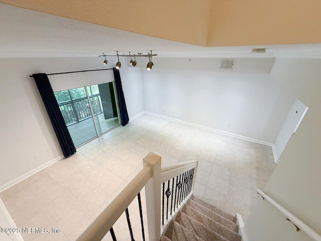 9745 Touchton Rd Unit 1929, Jacksonville, FL 32246 - staircase with vaulted ceiling, rail lighting, and tile patterned floors