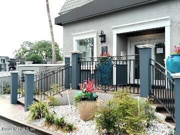 property entrance with stucco siding