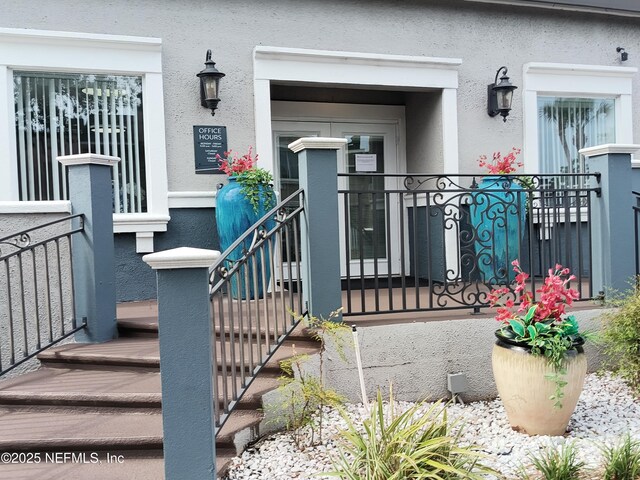 property entrance with stucco siding