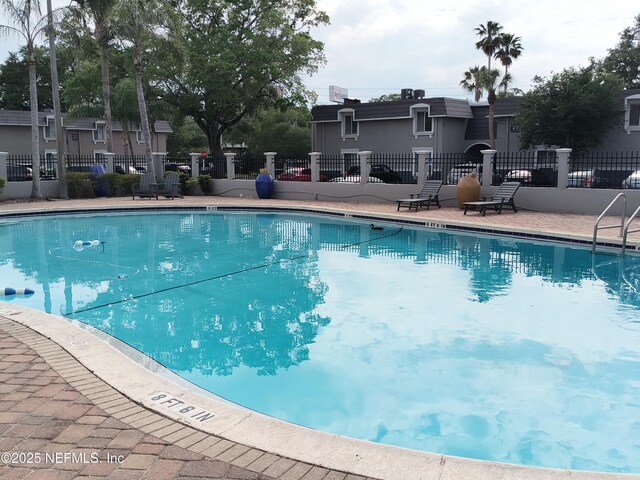community pool featuring fence