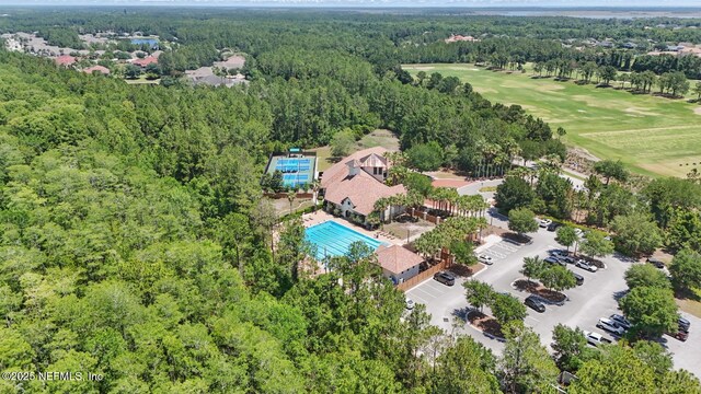 200 Paseo Terraza Unit 203, Saint Augustine, FL 32095 - drone / aerial view of a forest, a pool, and a local golf course