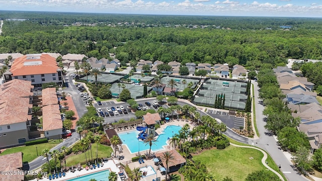 200 Paseo Terraza Unit 203, Saint Augustine, FL 32095 - aerial view of property and surrounding area featuring a pool, a heavily wooded area, and nearby suburban area