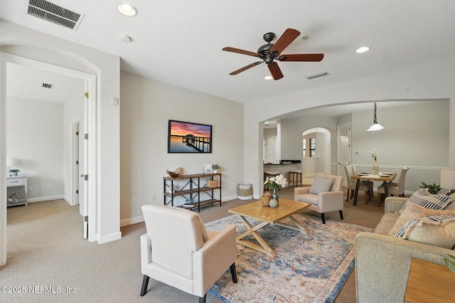 200 Paseo Terraza Unit 203, Saint Augustine, FL 32095 - living room featuring arched walkways, a ceiling fan, recessed lighting, baseboards, and light colored carpet