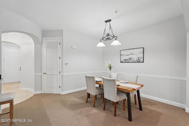 200 Paseo Terraza Unit 203, Saint Augustine, FL 32095 - dining space featuring arched walkways, light colored carpet, and baseboards