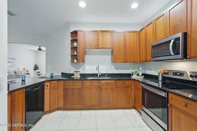 200 Paseo Terraza Unit 203, Saint Augustine, FL 32095 - kitchen with stainless steel appliances, a sink, open shelves, ceiling fan, and dark stone countertops