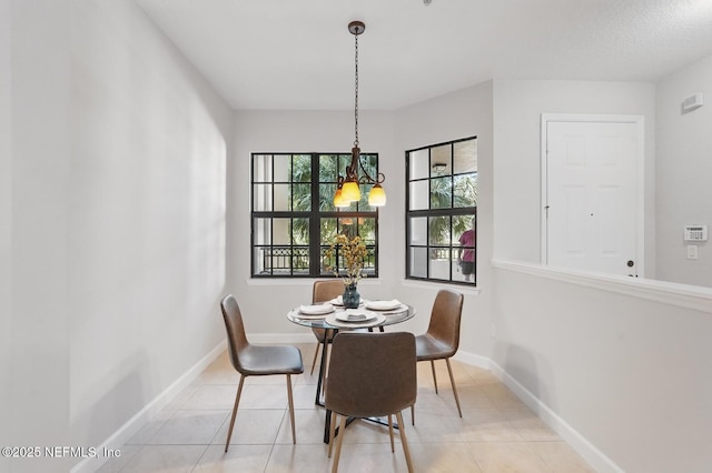 200 Paseo Terraza Unit 203, Saint Augustine, FL 32095 - dining area with a chandelier, tile patterned floors, and baseboards
