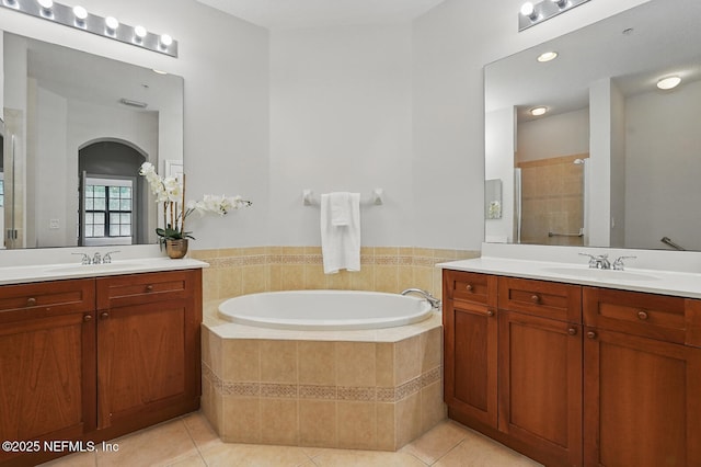 200 Paseo Terraza Unit 203, Saint Augustine, FL 32095 - bathroom with tile patterned flooring, two vanities, and a garden tub