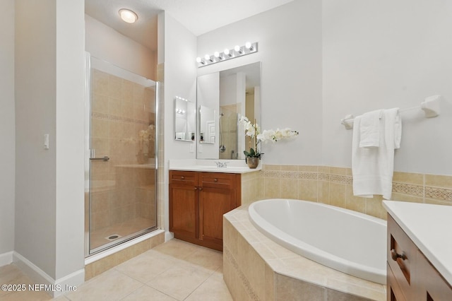 200 Paseo Terraza Unit 203, Saint Augustine, FL 32095 - bathroom featuring vanity, a bath, a stall shower, and tile patterned floors