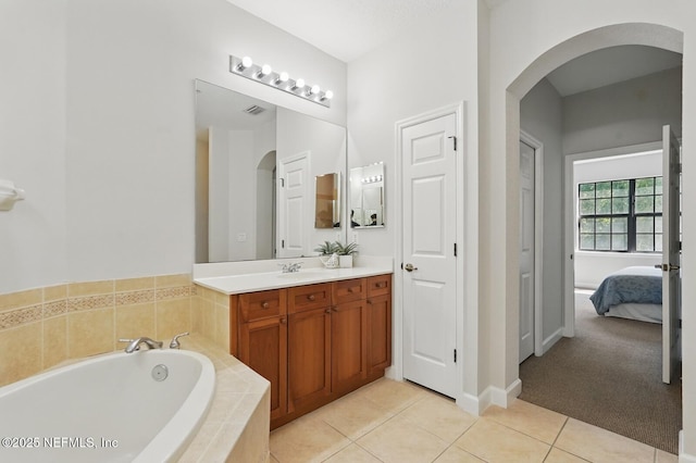 200 Paseo Terraza Unit 203, Saint Augustine, FL 32095 - bathroom with vanity, a garden tub, tile patterned flooring, ensuite bathroom, and baseboards