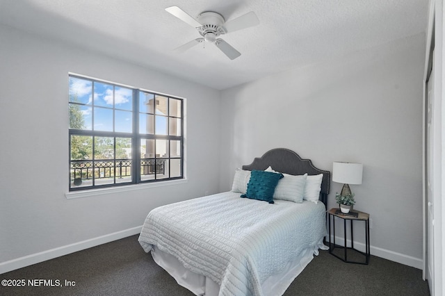200 Paseo Terraza Unit 203, Saint Augustine, FL 32095 - bedroom with dark carpet, baseboards, and a ceiling fan