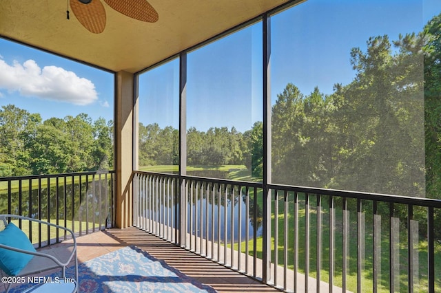 200 Paseo Terraza Unit 203, Saint Augustine, FL 32095 - unfurnished sunroom featuring ceiling fan, a water view, and view of wooded area
