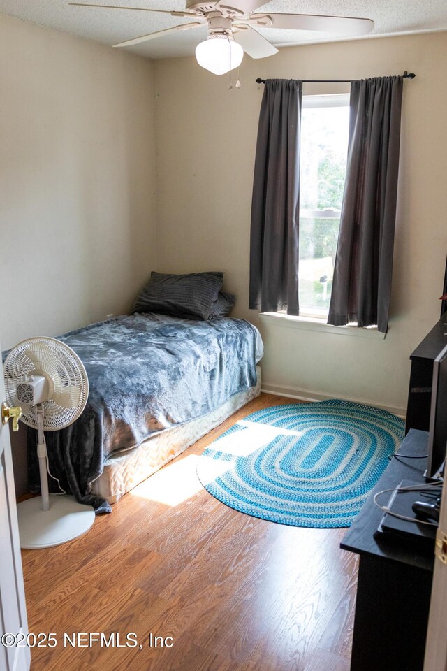 bedroom with wood finished floors and ceiling fan