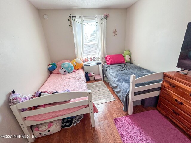 bedroom with wood finished floors