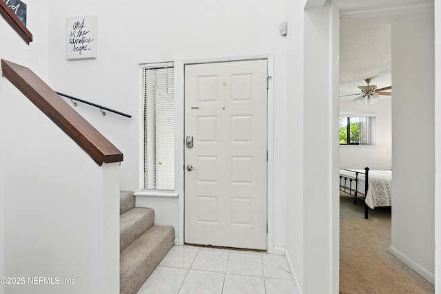 9360 Craven Rd Unit 1406, Jacksonville, FL 32257 - entrance foyer featuring stairway, light tile patterned floors, a ceiling fan, and baseboards