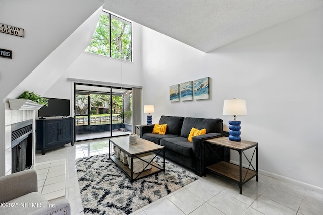9360 Craven Rd Unit 1406, Jacksonville, FL 32257 - tiled living room with high vaulted ceiling, baseboards, and a fireplace