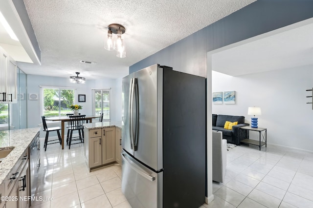 9360 Craven Rd Unit 1406, Jacksonville, FL 32257 - kitchen featuring stainless steel appliances, a textured ceiling, light tile patterned floors, a chandelier, and light stone countertops