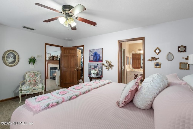 3041 Marrano Dr, Orange Park, FL 32073 - bedroom featuring carpet floors, a tile fireplace, ceiling fan, ensuite bathroom, and baseboards