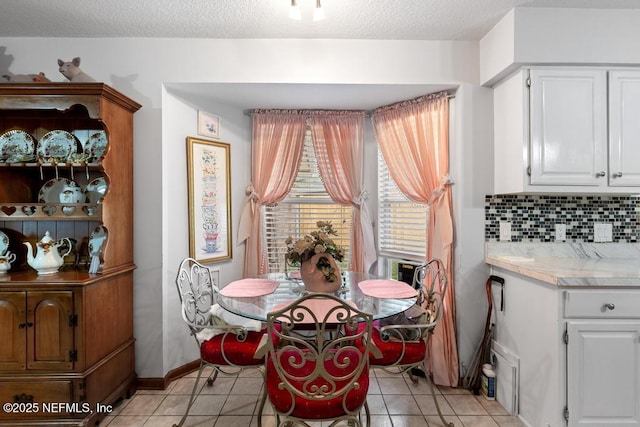 3041 Marrano Dr, Orange Park, FL 32073 - dining space with light tile patterned floors, baseboards, and a textured ceiling