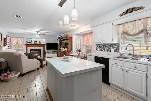 3041 Marrano Dr, Orange Park, FL 32073 - kitchen featuring a sink, dishwasher, a ceiling fan, a center island, and light tile patterned floors