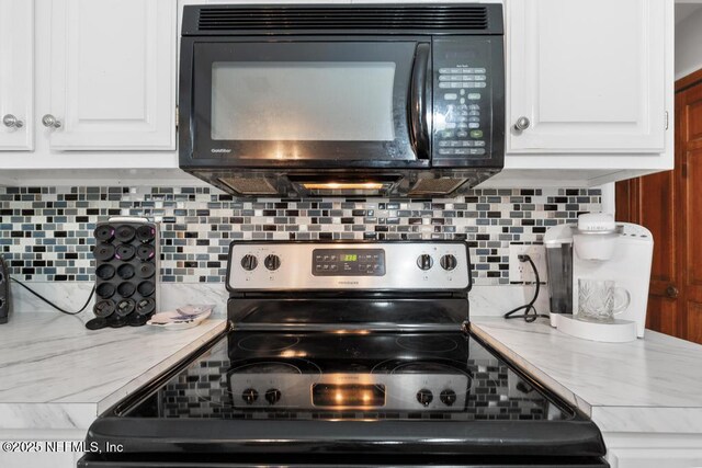 3041 Marrano Dr, Orange Park, FL 32073 - kitchen with electric range, black microwave, light countertops, and backsplash