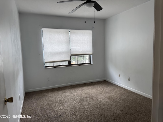 empty room with carpet floors, a ceiling fan, and baseboards