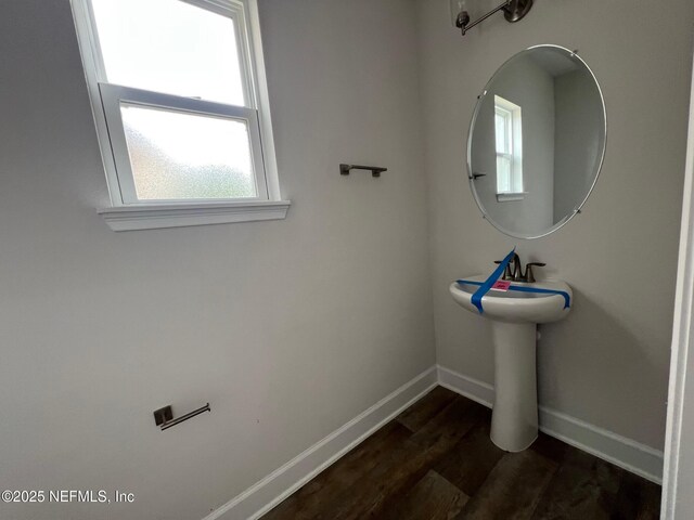 bathroom featuring baseboards, plenty of natural light, and wood finished floors