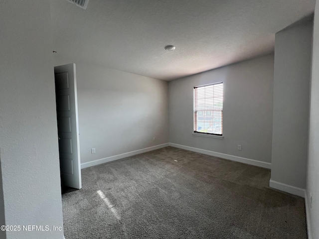 carpeted empty room with baseboards