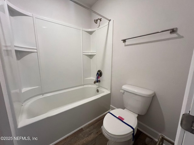 full bath with wood finished floors, toilet, baseboards, and shower / bathtub combination