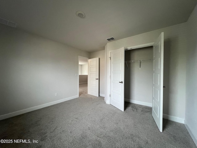 unfurnished bedroom with carpet floors, baseboards, and a closet
