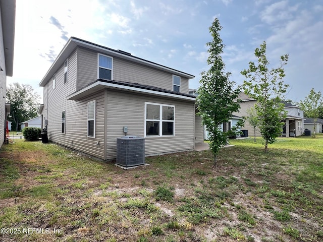 rear view of property featuring central AC unit