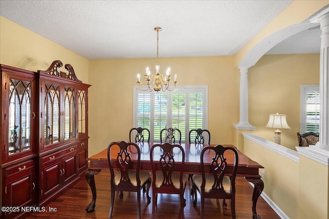 11092 Turnbridge Dr Unit 74, Jacksonville, FL 32256 - dining room featuring dark wood finished floors, baseboards, a chandelier, arched walkways, and a textured ceiling