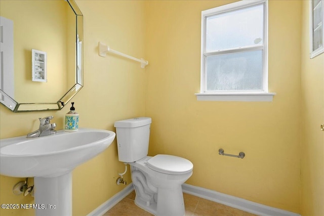 11092 Turnbridge Dr Unit 74, Jacksonville, FL 32256 - half bathroom featuring baseboards, toilet, tile patterned flooring, and a sink