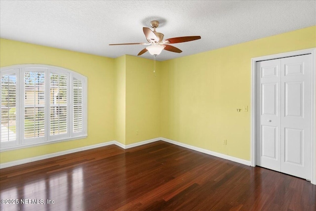 11092 Turnbridge Dr Unit 74, Jacksonville, FL 32256 - unfurnished bedroom with wood finished floors, baseboards, a textured ceiling, a ceiling fan, and a closet