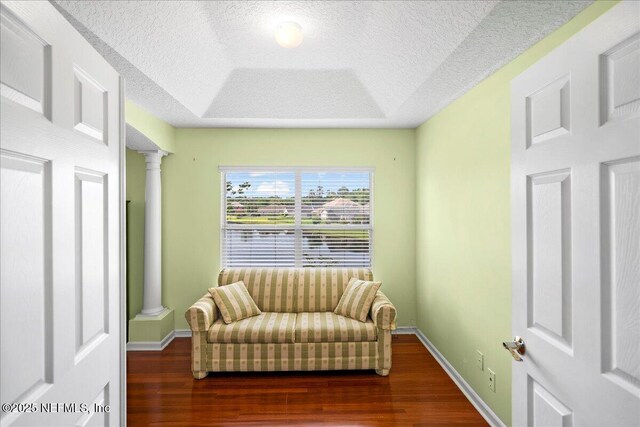 11092 Turnbridge Dr Unit 74, Jacksonville, FL 32256 - sitting room with decorative columns, a textured ceiling, wood finished floors, baseboards, and a raised ceiling