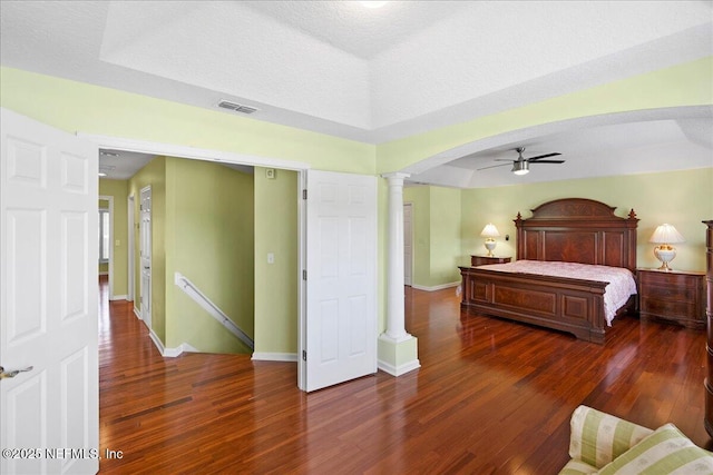 11092 Turnbridge Dr Unit 74, Jacksonville, FL 32256 - bedroom featuring ornate columns, wood finished floors, arched walkways, baseboards, and ceiling fan